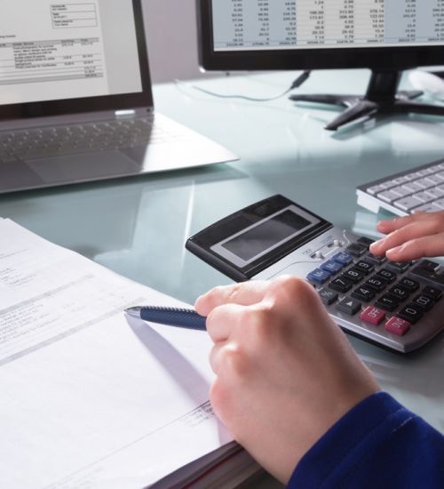 Accountant,Using,Calculator,For,Electronic,Bill,On,Laptop